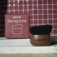 A NAVVE Blurring Brush with a brown handle and black bristles