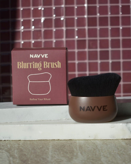 A NAVVE Blurring Brush with a brown handle and black bristles